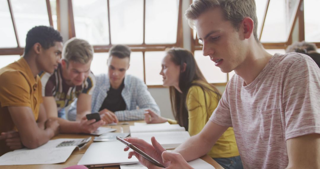 Diverse High School Students Engaged with Smartphones in Classroom