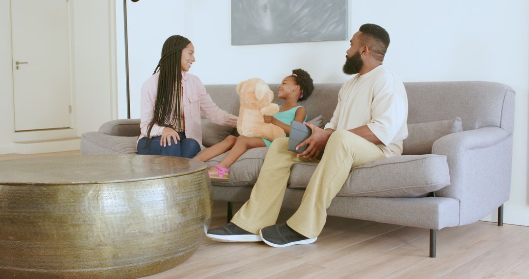 Family Bonding Time on Sofa with Tablet and Teddy Bear