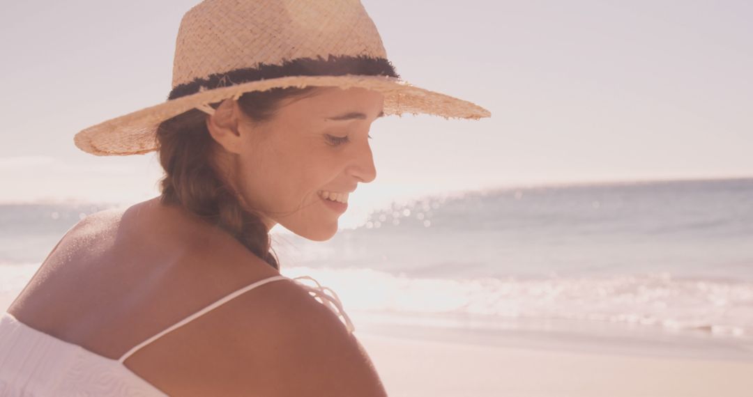 Young Woman Smiling at Beach, Wearing Sun Hat - Free Images, Stock Photos and Pictures on Pikwizard.com