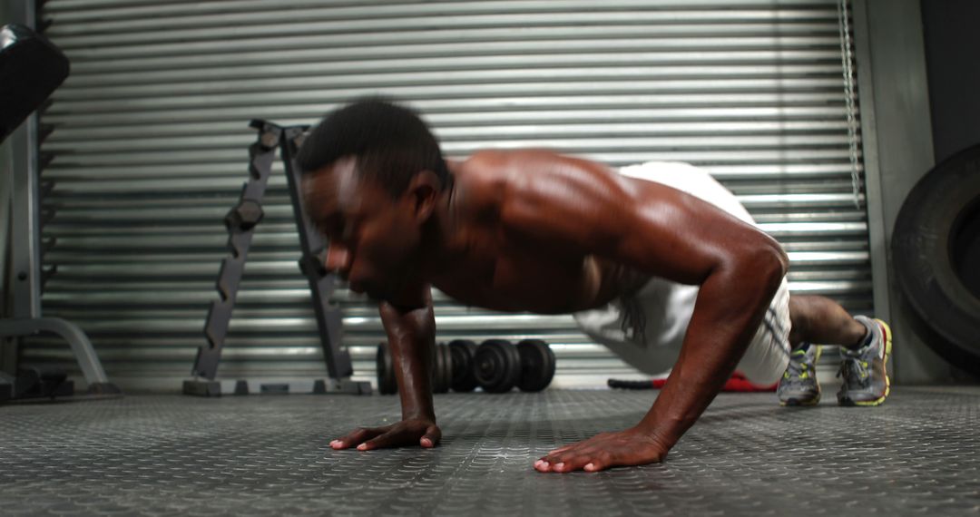 Focused Man Performing Push-Ups in Industrial Gym Setting - Free Images, Stock Photos and Pictures on Pikwizard.com