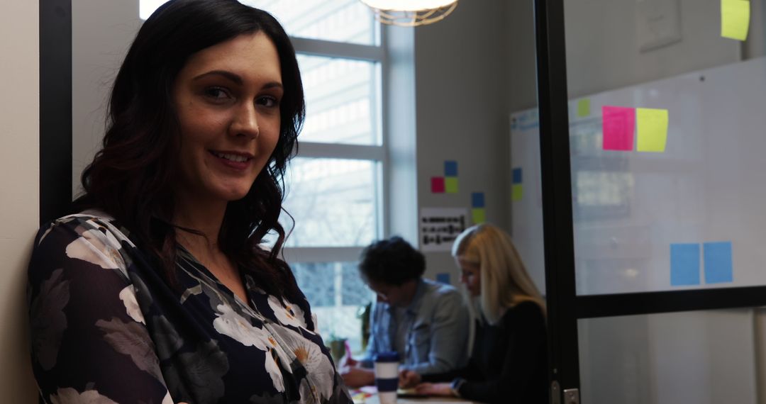 Confident Professional Standing in Modern Office Environment