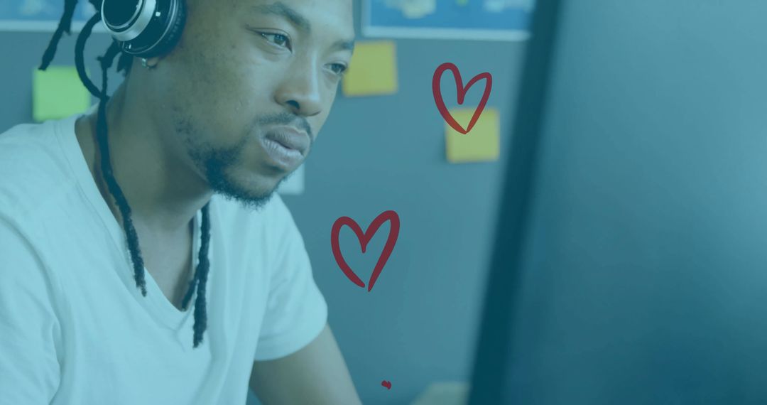 Focused Man in T-Shirt Wearing Headphones and Working at Computer Monitor