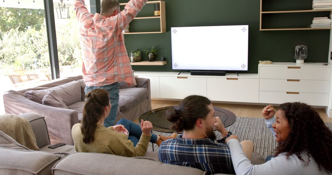 Friends Enjoying Video Game in Modern Living Room - Free Images, Stock Photos and Pictures on Pikwizard.com