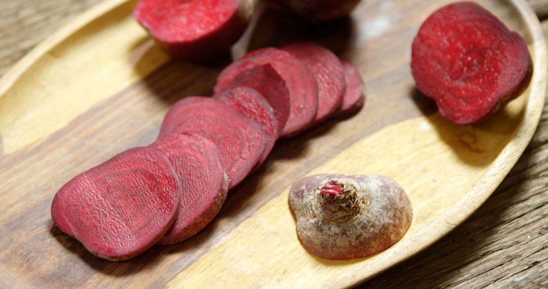 Freshly Cut Beetroot Slices and Whole Beetroot on Wooden Plate - Free Images, Stock Photos and Pictures on Pikwizard.com