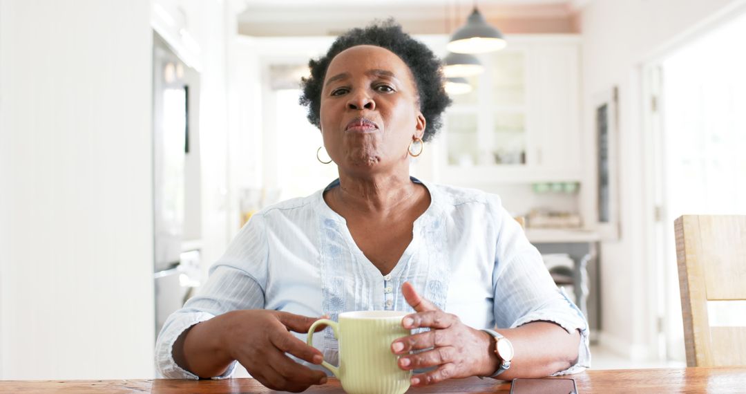 Senior Woman Drinking Coffee at Home and Looking Thoughtful - Free Images, Stock Photos and Pictures on Pikwizard.com