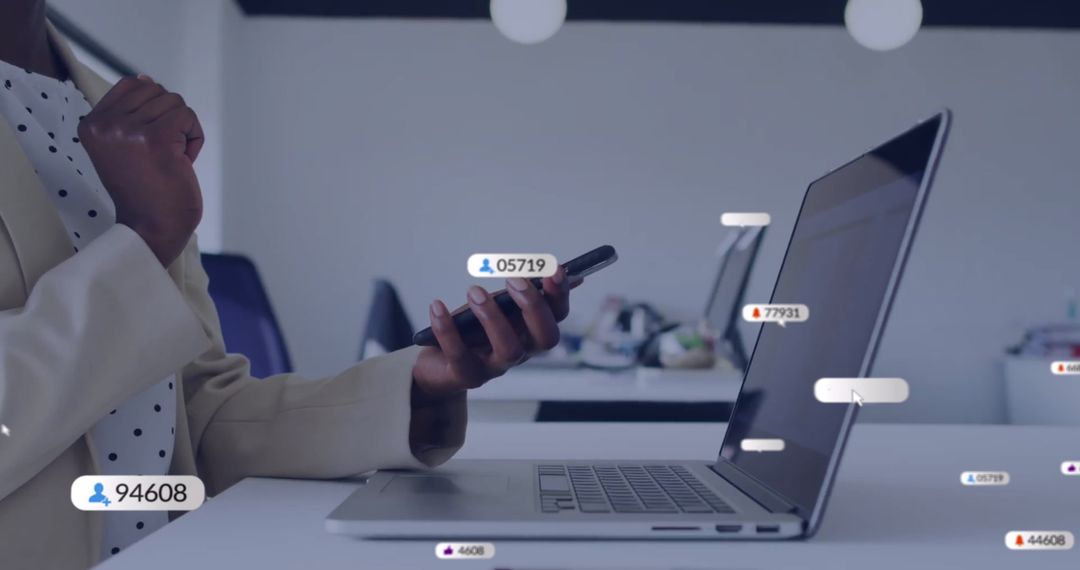 Businesswoman Analyzing Data Using Smartphone and Laptop