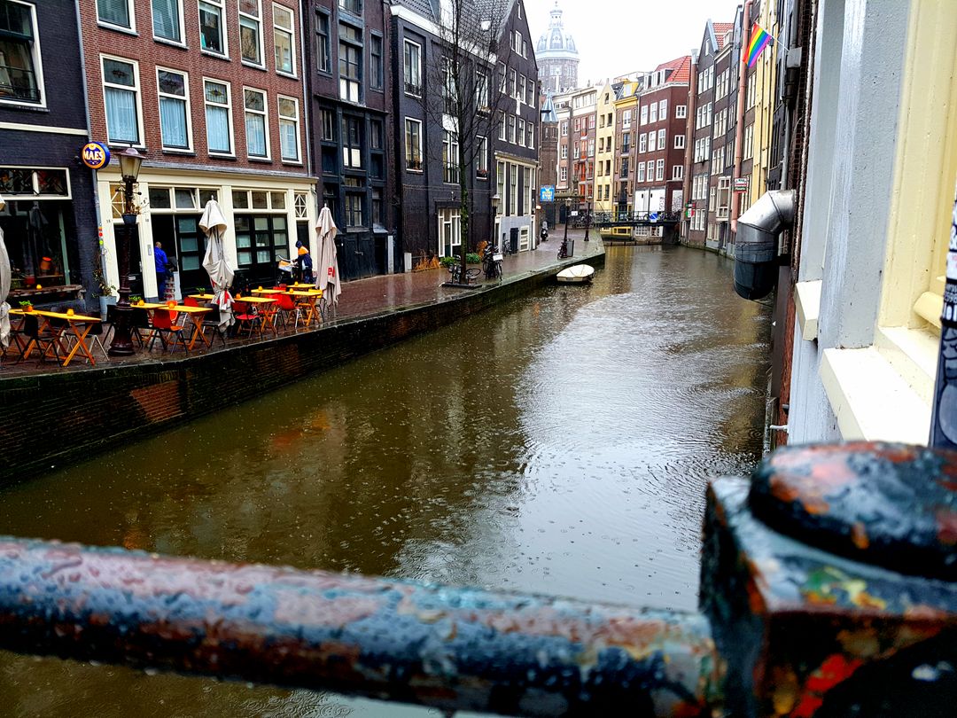 Rainy day along colorful canal in Amsterdam - Free Images, Stock Photos and Pictures on Pikwizard.com