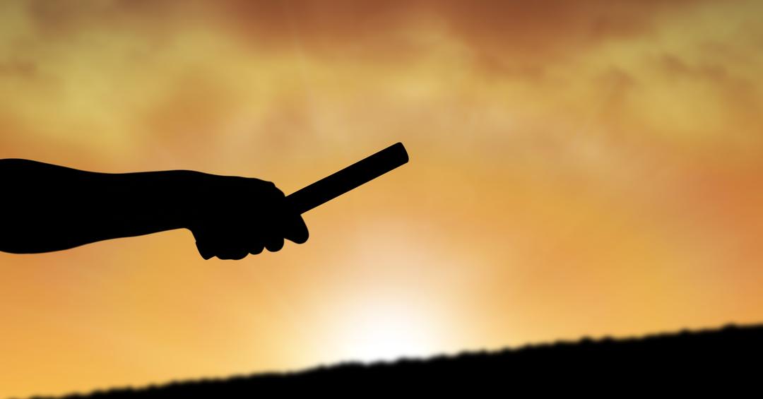 Silhouette Hand Holding Relay Baton Against Sky at Sunset - Free Images, Stock Photos and Pictures on Pikwizard.com