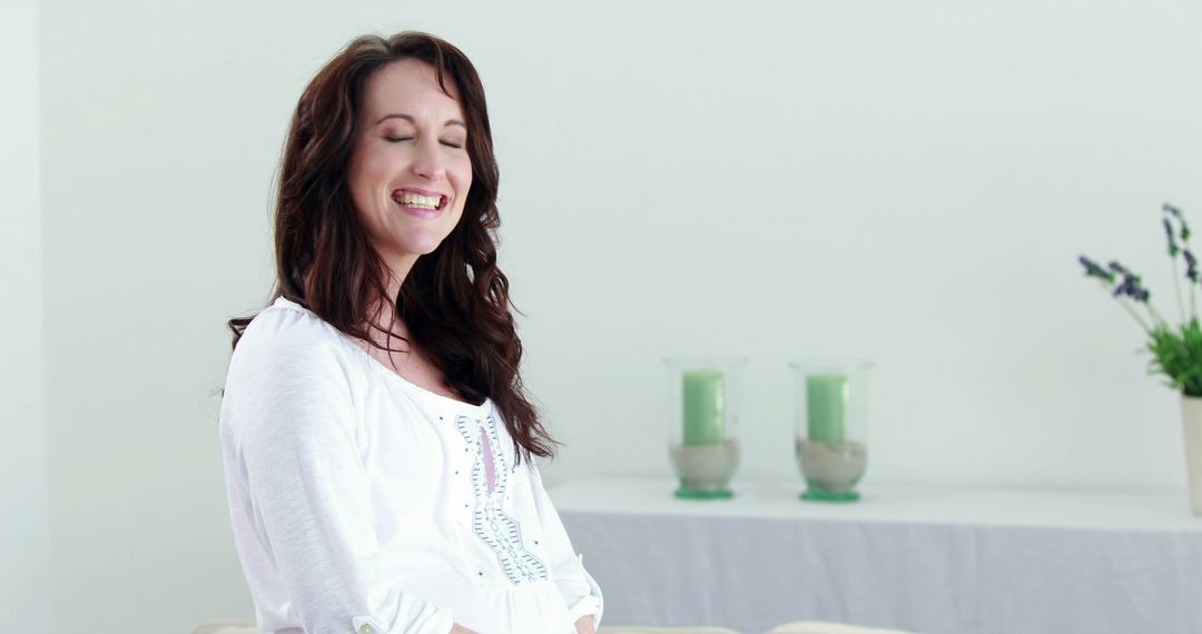 Pregnant Woman Smiling with Joy in Bright Living Room - Free Images, Stock Photos and Pictures on Pikwizard.com