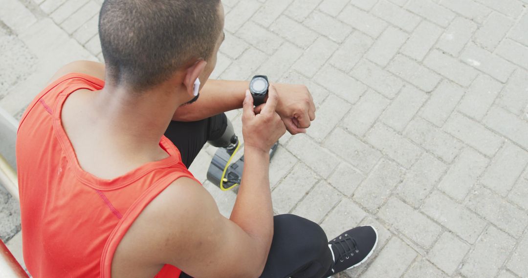 Male Athlete Resting and Checking Smartwatch After Running - Free Images, Stock Photos and Pictures on Pikwizard.com