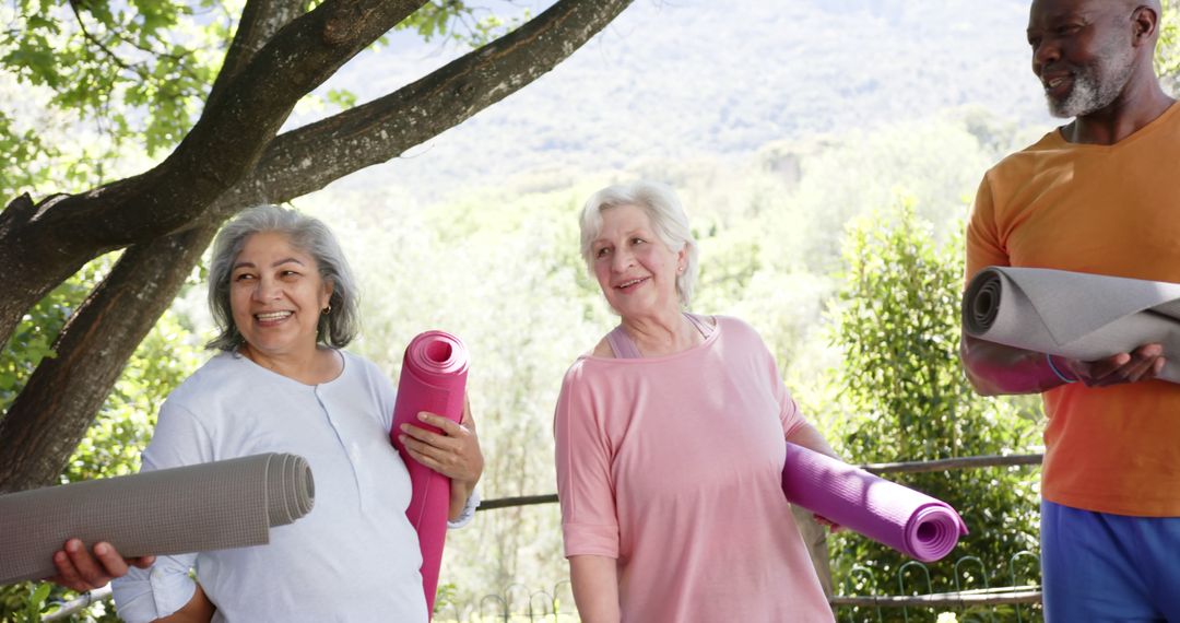 Senior Adults Smiling and Holding Yoga Mats Outdoors in Nature - Free Images, Stock Photos and Pictures on Pikwizard.com