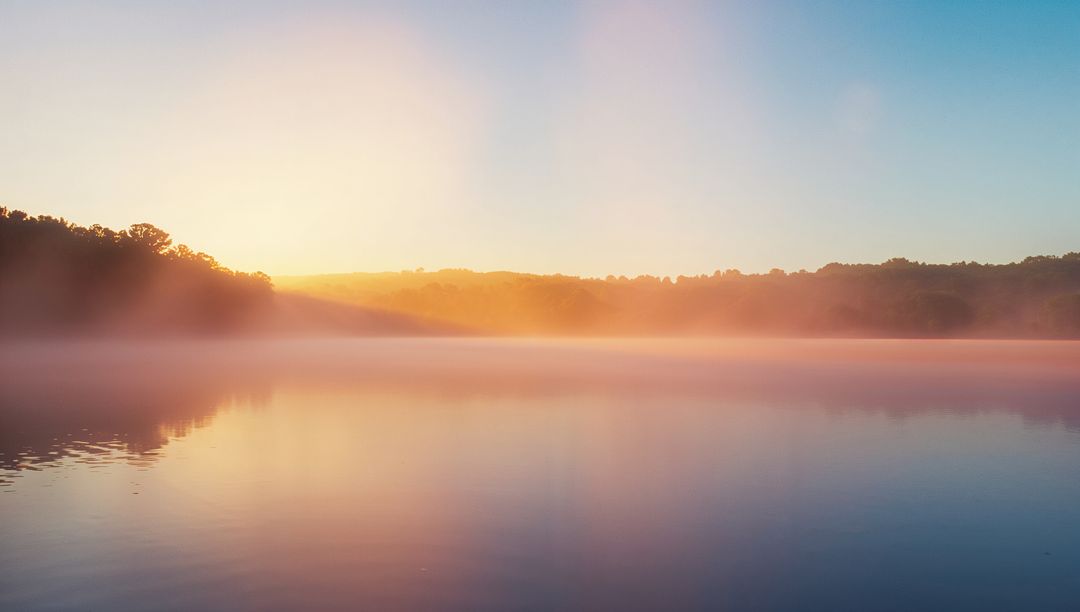Misty Sunrise Over Serene Lake with Forest Reflection