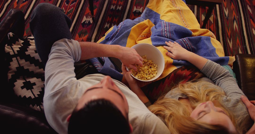 Couple Relaxing on Couch with Popcorn at Home