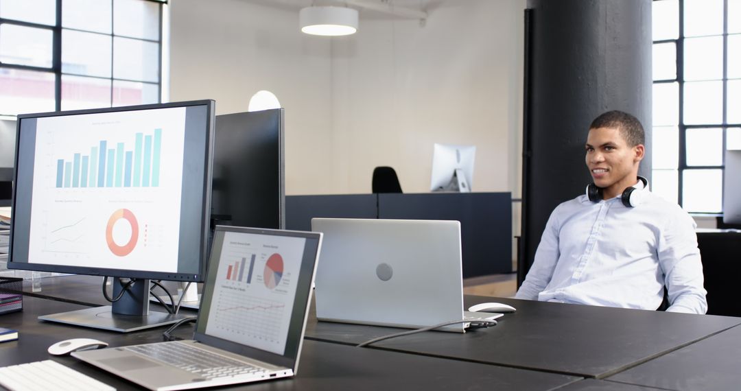 Business People Analyzing Reports on Computer Screens in Modern Office