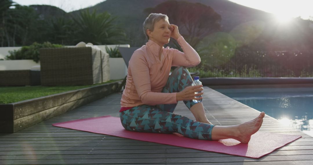 Senior Woman Practicing Yoga Outdoors and Relaxing Near Pool - Free Images, Stock Photos and Pictures on Pikwizard.com