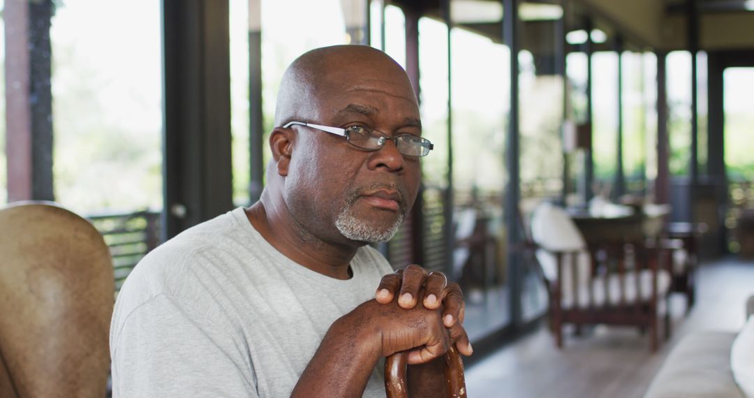 Mature African American Man with Glasses Looking Thoughtful Indoors - Free Images, Stock Photos and Pictures on Pikwizard.com