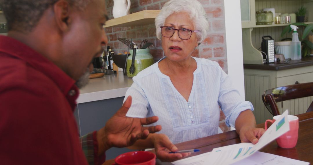 Senior Couple Analyzing Bills in Kitchen