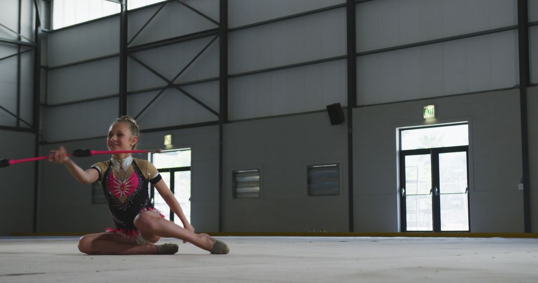 Young Gymnast Practicing Rhythmic Gymnastics with Baton - Free Images, Stock Photos and Pictures on Pikwizard.com