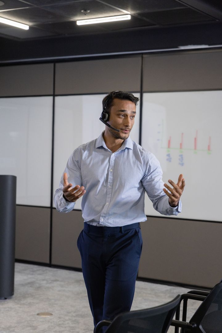 Businessman Presenting Data with Charts in Modern Boardroom