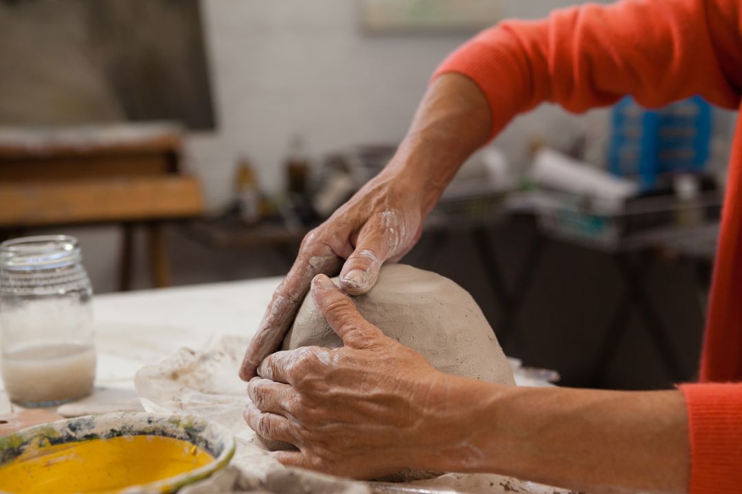 Mid-section of senior woman molding clay - Free Images, Stock Photos and Pictures on Pikwizard.com