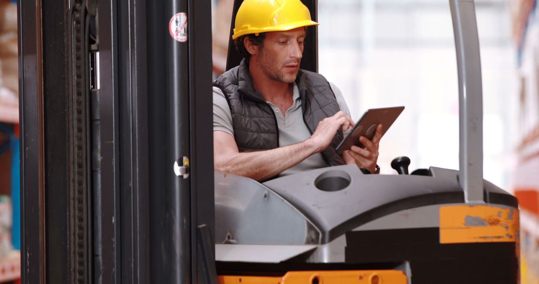 Warehouse Worker Operating Forklift and Using Tablet - Free Images, Stock Photos and Pictures on Pikwizard.com