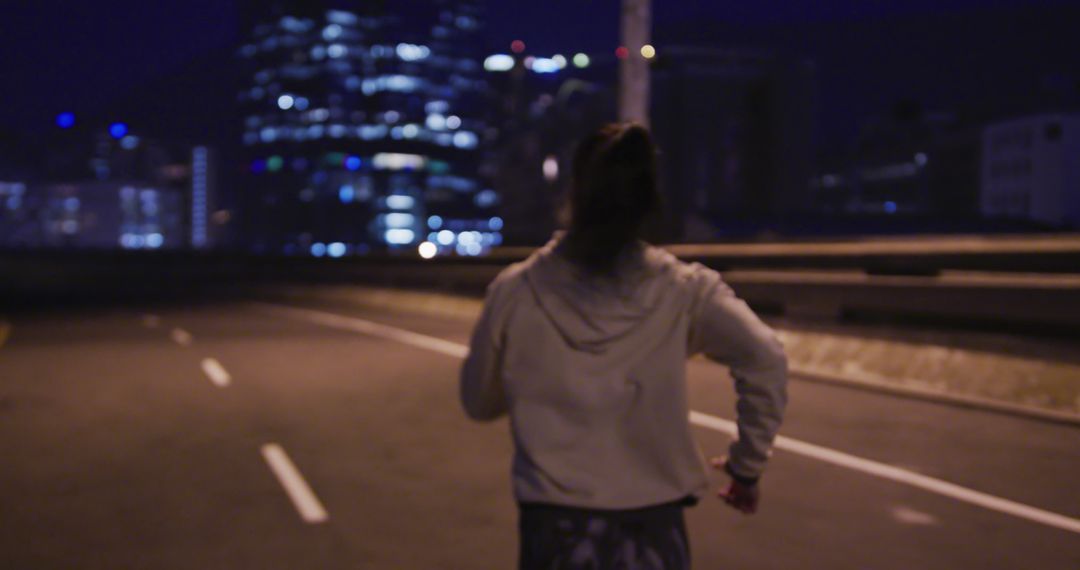 Young Woman Running on Empty Road at Night - Free Images, Stock Photos and Pictures on Pikwizard.com