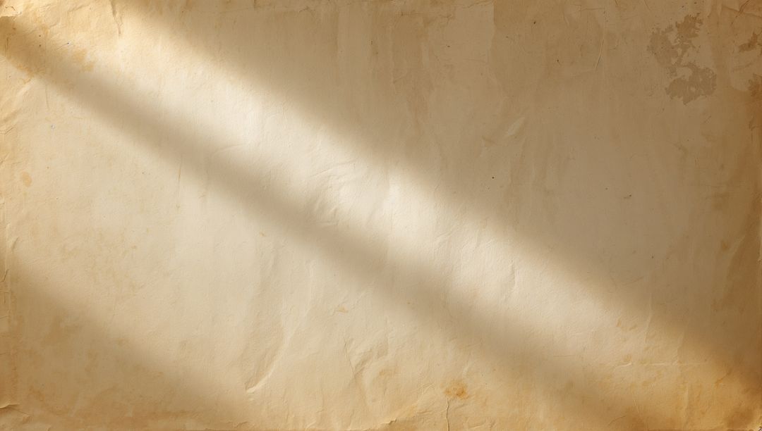 Vintage aged parchment showing diagonal sunlight, creases and foxing for background texture