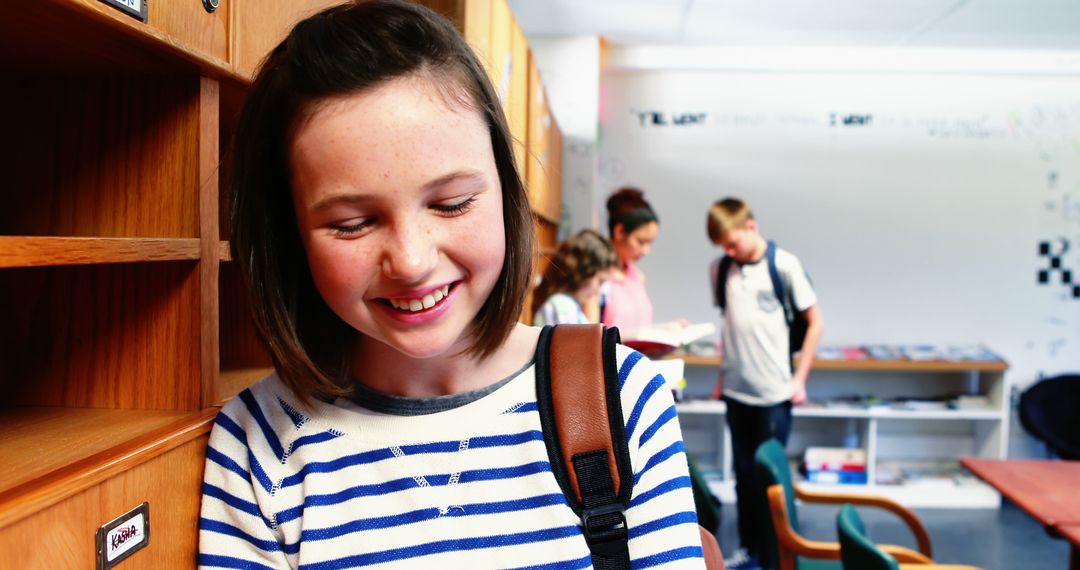 Smiling Girl in School Hallway with Classmates Studying in Background - Free Images, Stock Photos and Pictures on Pikwizard.com