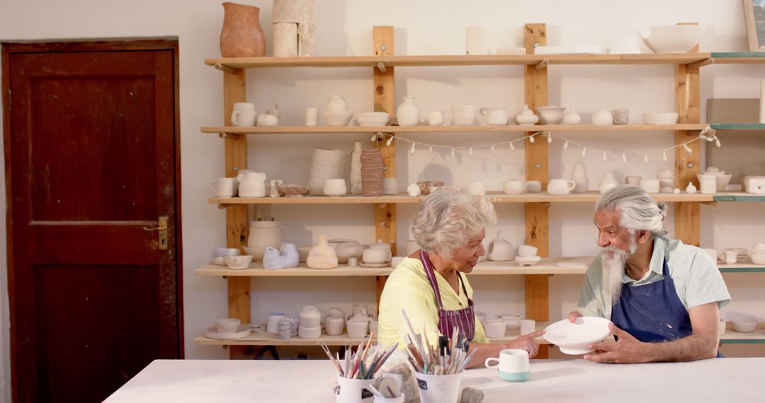 Senior couple enjoying pottery class in studio - Free Images, Stock Photos and Pictures on Pikwizard.com