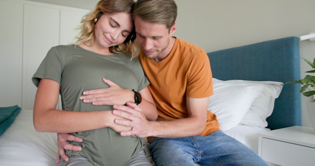 Expectant Couple Embracing Pregnancy Journey in Cozy Home Environment
