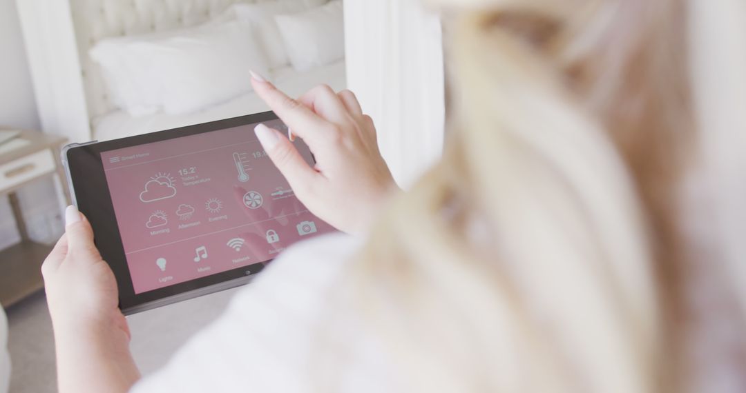 Woman Controlling Smart Home System with Tablet in Bedroom - Free Images, Stock Photos and Pictures on Pikwizard.com