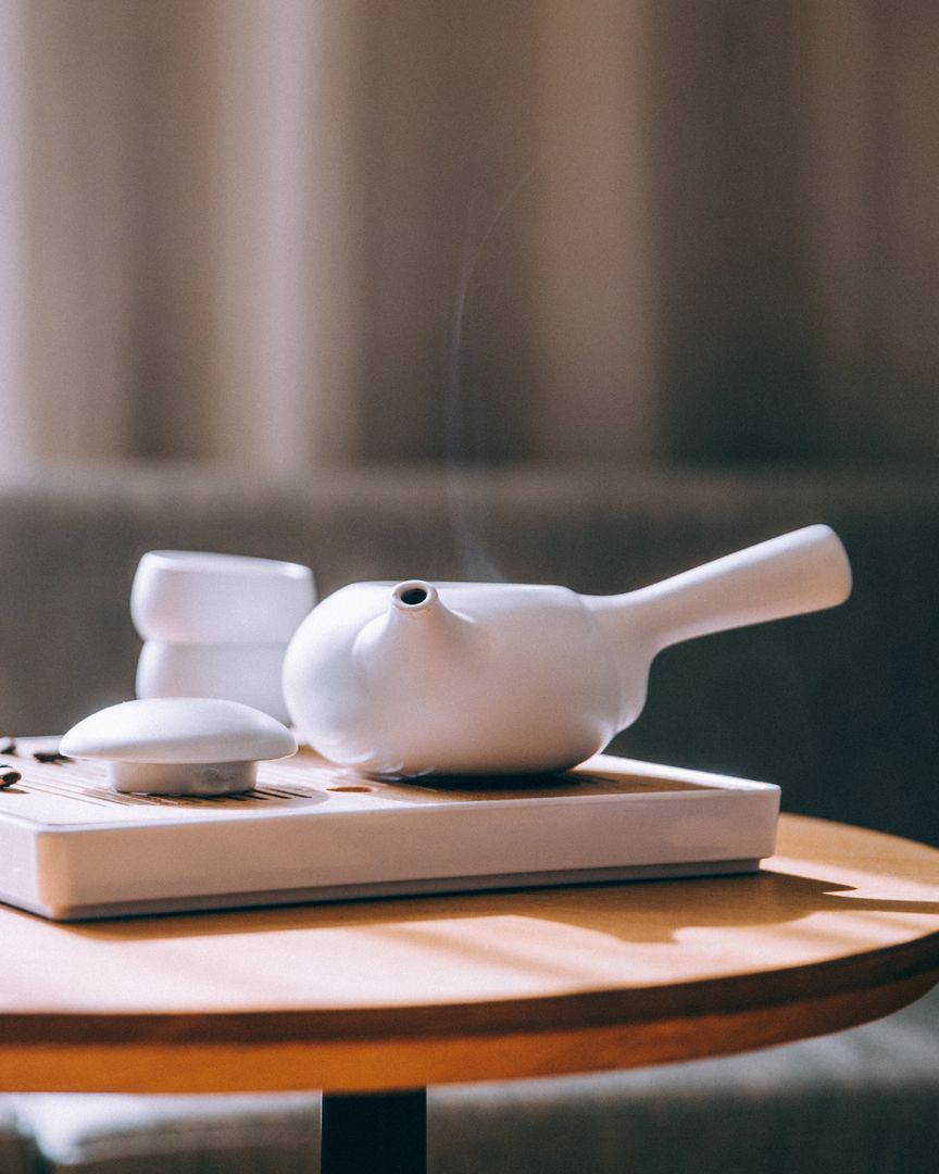 Elegant Modern Teapot Inviting Relaxation, Warm Layered Ambiance