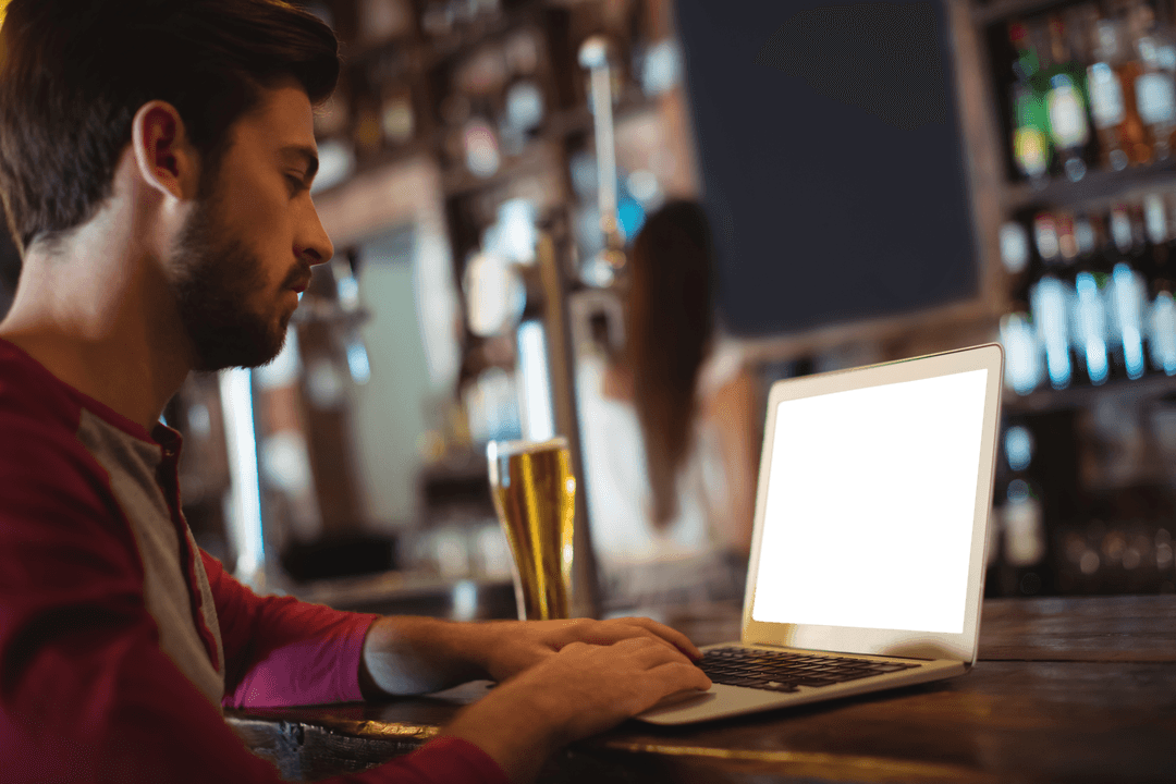 man browsing laptop at bar counter with transparent screen - Download Free Stock Images Pikwizard.com