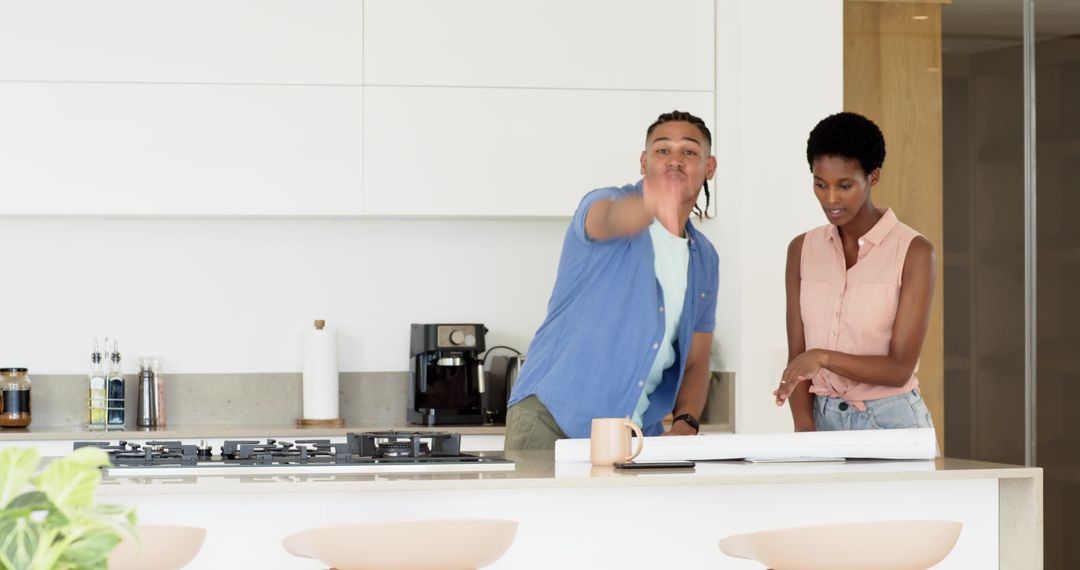 Diverse Couple Evaluating Architectural Plans in Chic Kitchen