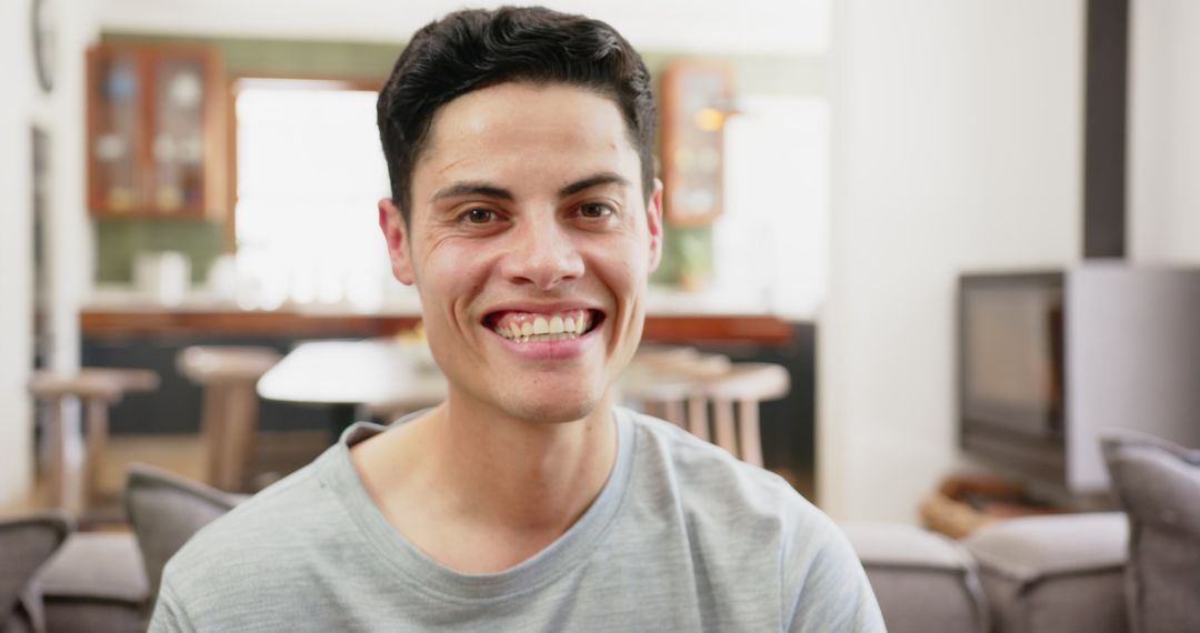 Smiling Mixed-Race Man Relaxing at Home in Warm Ambiance