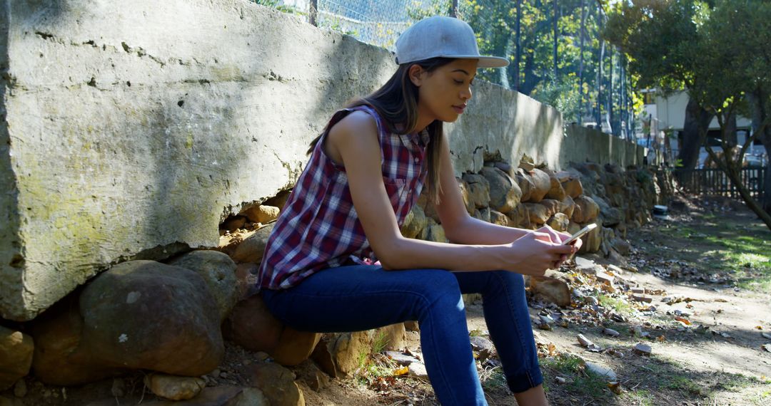 Young Woman Relaxing Outdoors Using Smartphone in Park - Free Images, Stock Photos and Pictures on Pikwizard.com