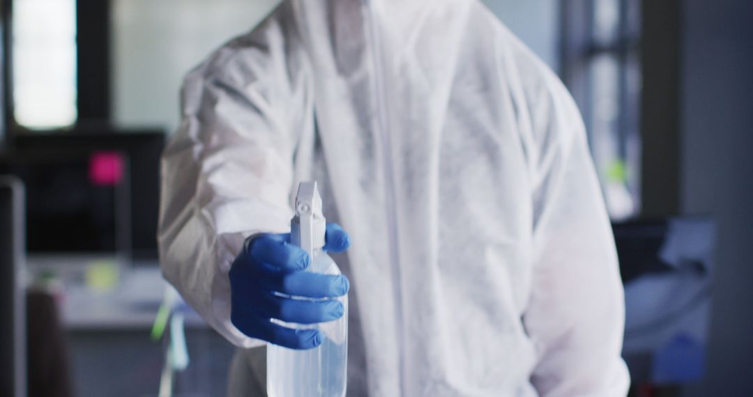 Technician in Hazmat Suit Disinfecting Office with Spray Bottle - Free Images, Stock Photos and Pictures on Pikwizard.com