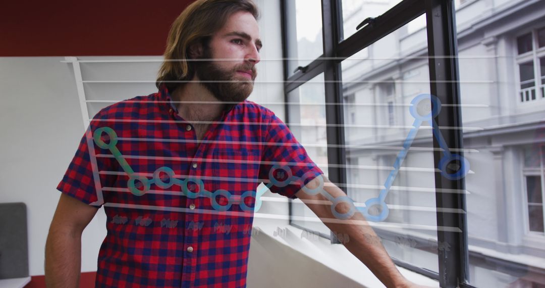 Young Professional Gazing Out Office Window with Business Graph Overlay