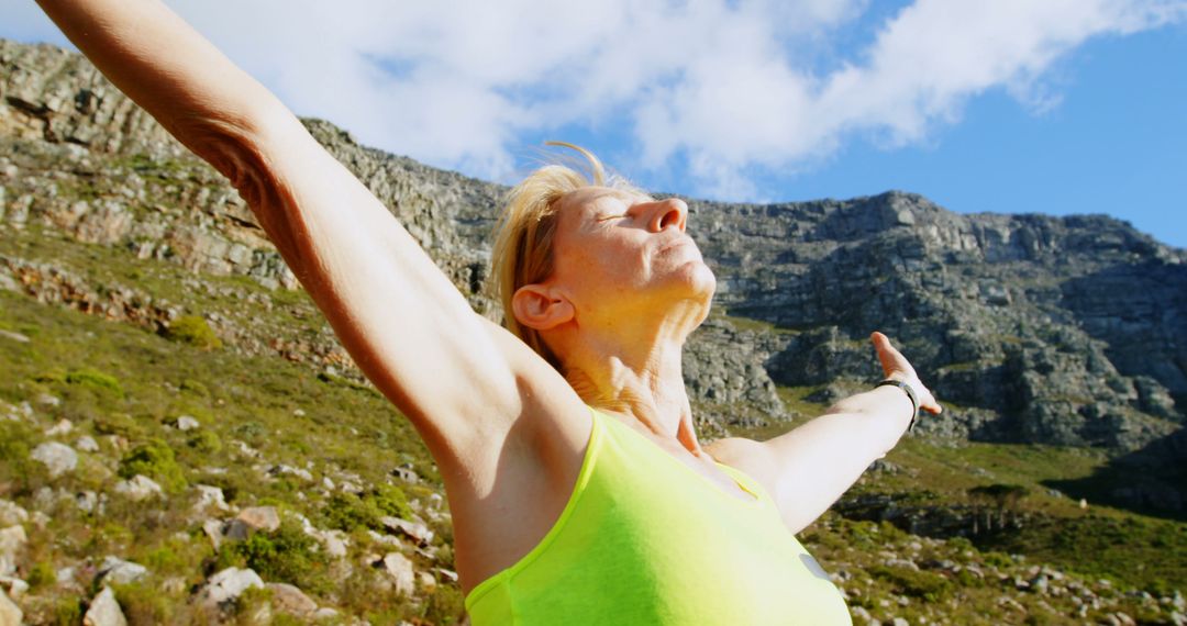 Senior Woman Enjoying Freedom in Mountain Landscape - Free Images, Stock Photos and Pictures on Pikwizard.com