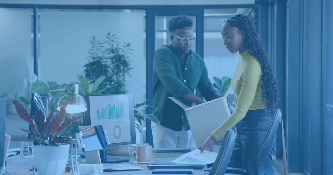 Collaborative Office Team Reviewing Analytics and Reports in Modern Minimalist Workspace