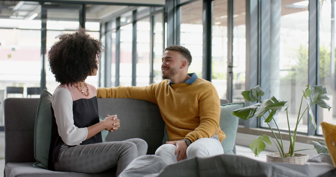 Diverse Professionals Engaged in Informal Office Conversation