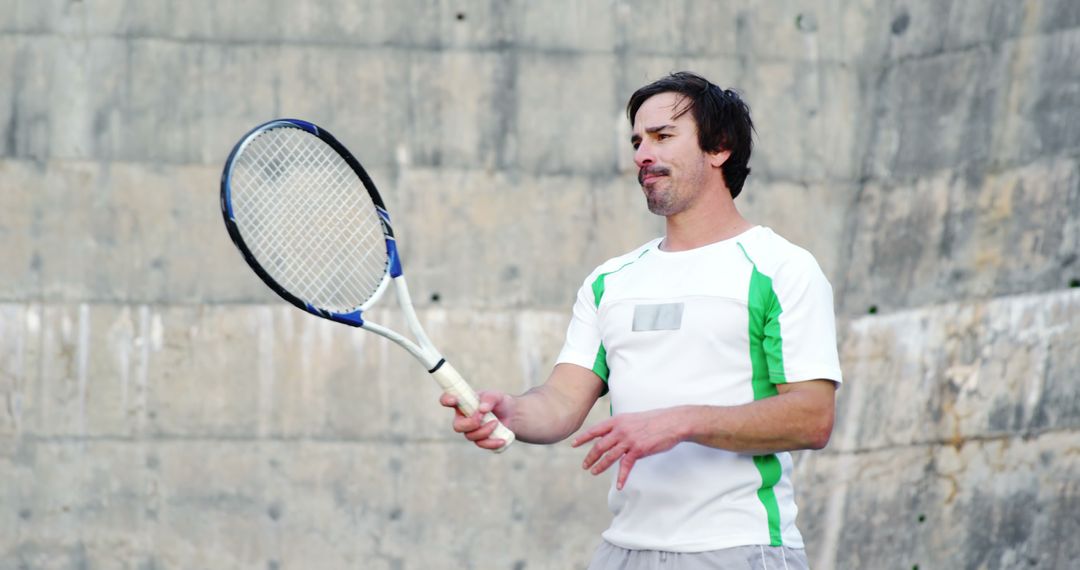 Man Practicing Tennis Against Concrete Wall - Free Images, Stock Photos and Pictures on Pikwizard.com