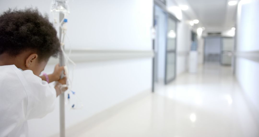 Young Patient Navigating Hospital Corridor With IV Stand - Free Images, Stock Photos and Pictures on Pikwizard.com