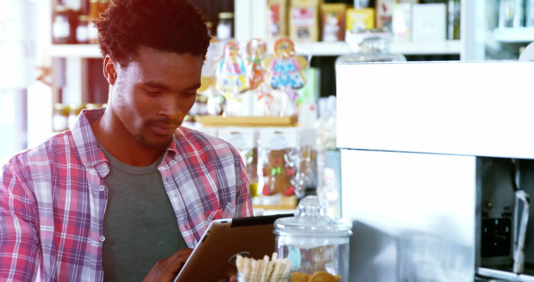Man Using Digital Tablet in Casual Cafe Setting