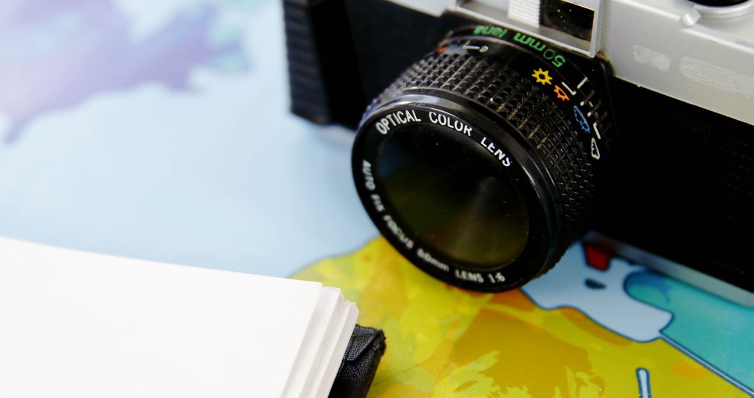 Vintage Camera on Map with Notebook Ready for Adventure