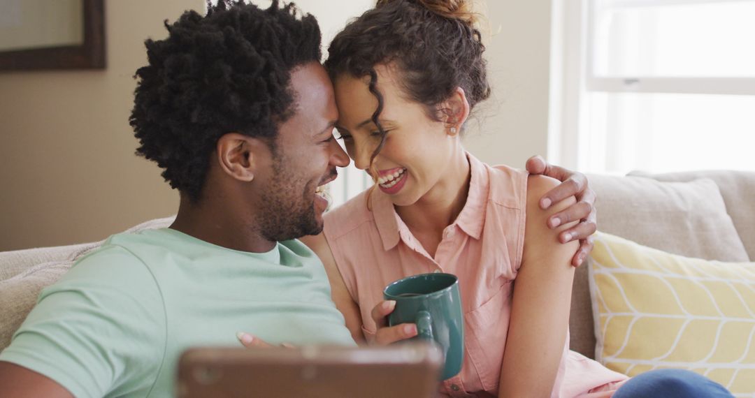 Happy Couple Relaxing on Sofa and Video Calling
