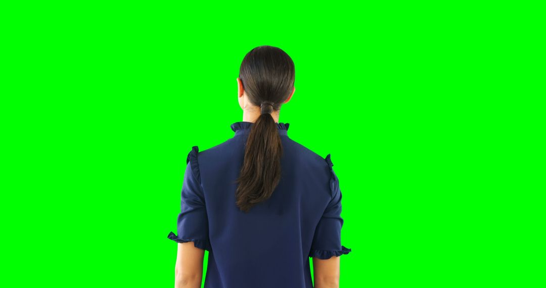 Rear View Businesswoman Engaging with Virtual Interface on Green Screen