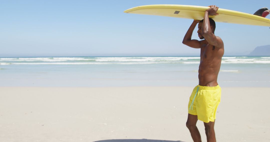 Man Carrying Surfboard on Sandy Beach on Sunny Day - Free Images, Stock Photos and Pictures on Pikwizard.com