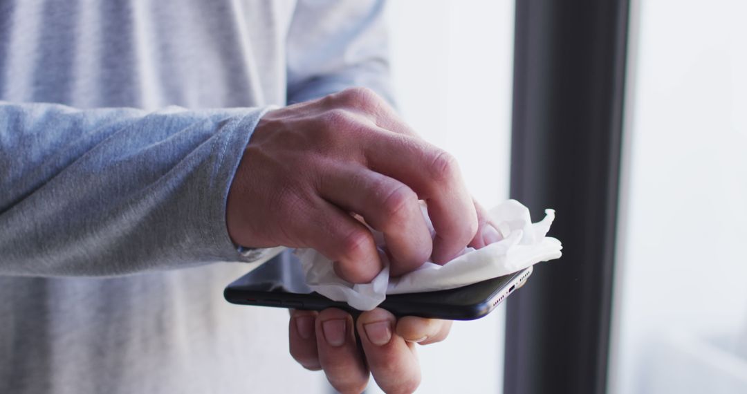 Man Cleaning Smartphone Screen with Disinfectant Wipe - Free Images, Stock Photos and Pictures on Pikwizard.com