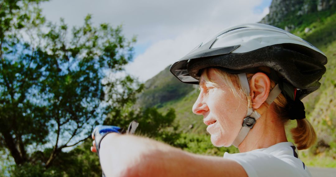 Outdoor Cyclist Points Towards Exciting Adventure